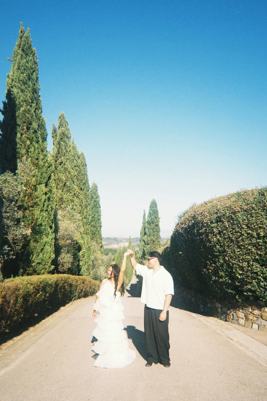 Ralph and Jasmine walking together in a Tuscan garden