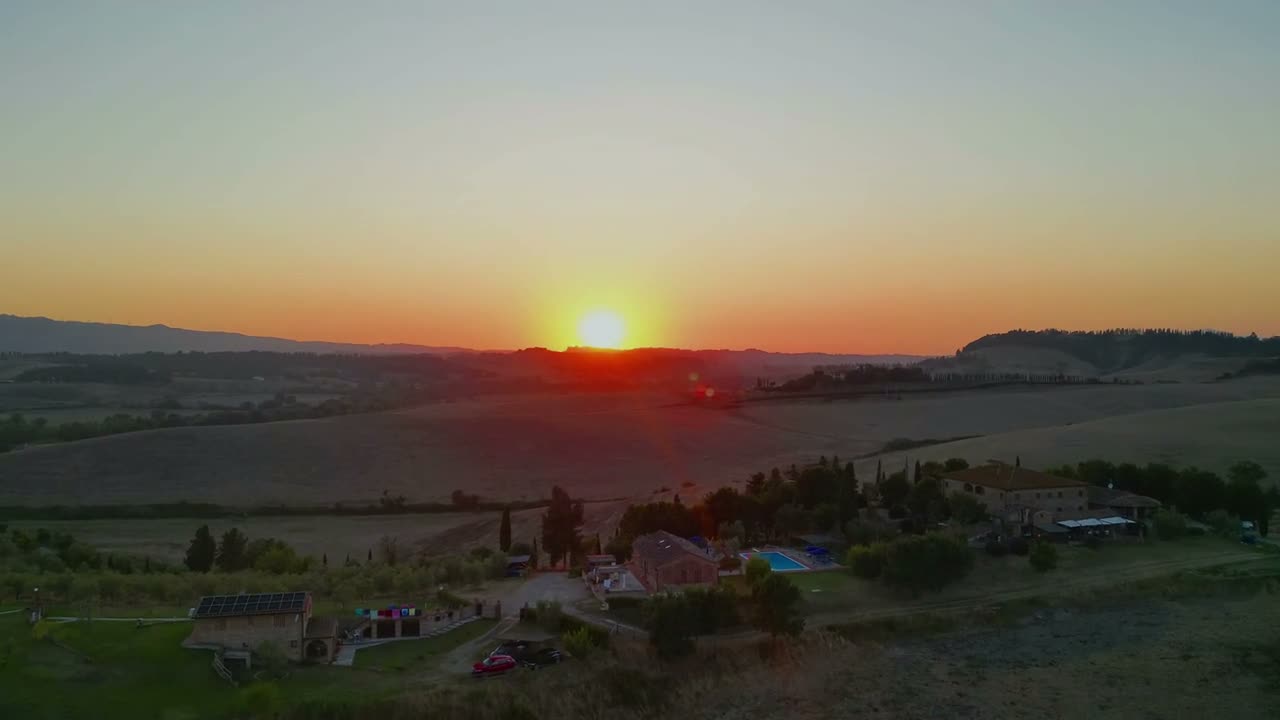 The sun setting over the rolling hills of Tuscany